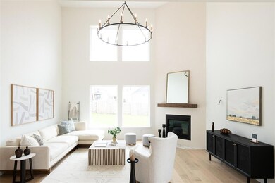 Living area with a chandelier, light wood finishe
