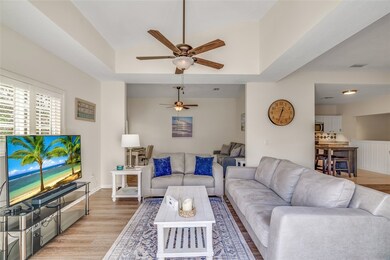 Spacious living room w/plantation shutters -- view