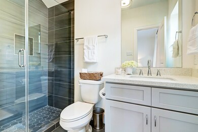 Full bath with quartz countertops and walk-in show