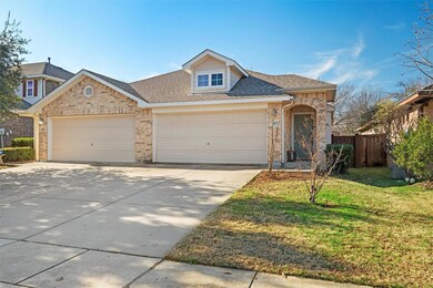 View of front of home with a front yard and a gara