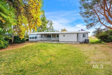 Back of house featuring a yard and a wooden deck
