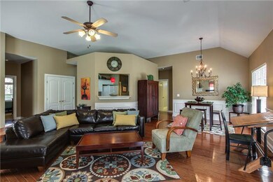 This is a Great Floor Plan with Beautiful Paint Colors and Trim Throughout.  Natural Light Fills This Stunning Room! The Kitchen and Counter Area are Located Directly Behind the Sofa!  You can See the Double Pantry Doors to the Left. 