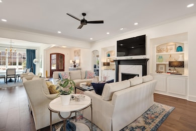 Living room with arched walkways, wood finished fl