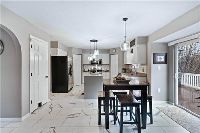 Updated trendy kitchen with modern light fixtures