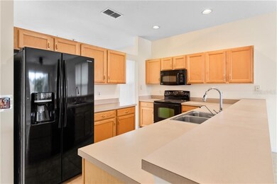 This kitchen offers lots of cupboard space, counter surfaces, and a panty too!
