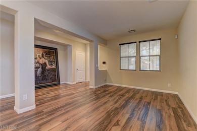 Unfurnished room with wood finished floors and bas