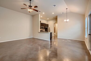 Unfurnished living room featuring concrete floors, arched walkways, a ceiling fan, recessed lighting, and vaulted ceiling