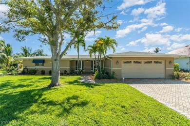Ranch-style home featuring a front lawn and a gara
