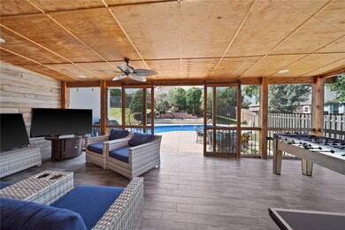 The covered patio is a seamless extension of the indoor living space, offering a sheltered retreat for outdoor enjoyment regardless of the weather.