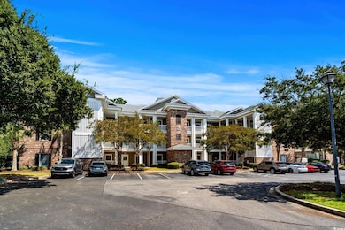 View of property with uncovered parking