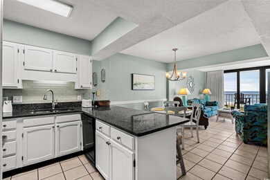 Kitchen featuring an inviting chandelier, black di