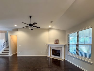 Unfurnished living room with a fireplace, wood fin