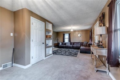 The living room off of the front porch and den! Ne