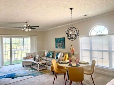 Living room featuring carpet floors, a textured ce