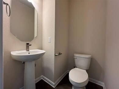Bathroom with toilet and baseboards