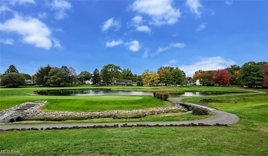 View of home's community with a lawn and a water view