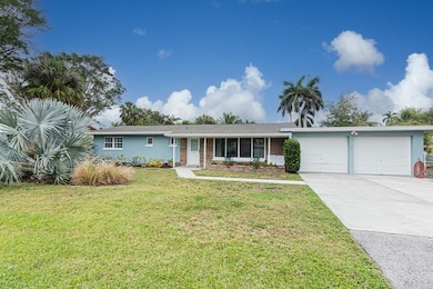 Mid Century Charm ! On the water. 2 car extended garage. Engineered Wood to enhance entry