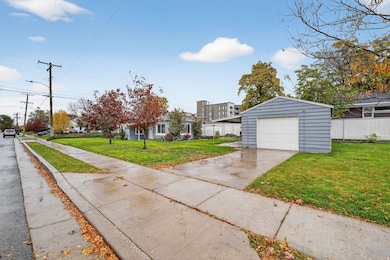 View of front of house featuring an outbuilding, driveway, and a garage