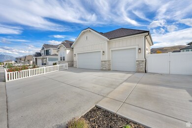Ranch-style house featuring stone siding, concrete driveway, an attached garage, and board and batten siding