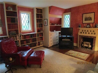 Den with fireplace and bookcases