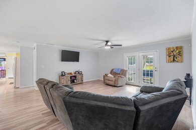 Living room featuring ceiling fan, light hardwood 