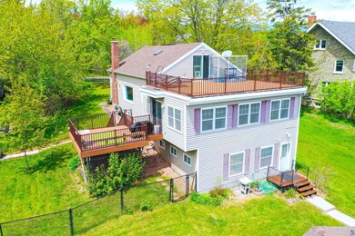 Back of house with a wooden deck and a chimney