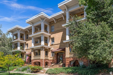 View of front of house with brick siding and a balcony