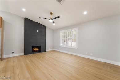 Unfurnished living room featuring vaulted ceiling,