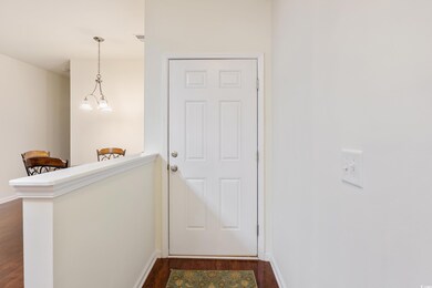 Doorway to outside with dark wood-style floors