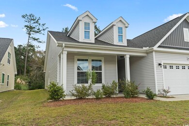 View of front of home featuring covered porch, a g