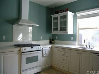 Pristine all white kitchen with convenient direct 