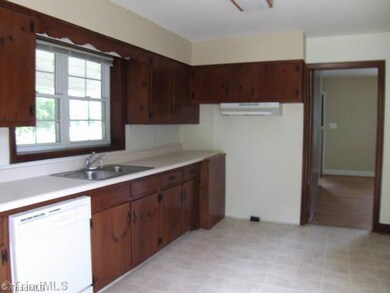 Kitchen. Another view of the kitchen, shows a dishwasher and the range is coming, floor is almost new, and you see the nice window over the sink...