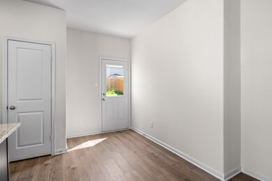 Entrance foyer featuring light wood-style floors and baseboards