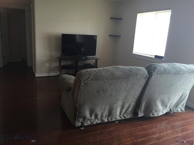 NICE LIGHT LIVING ROOM WITH HARDWOOD FLOORING.