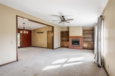 Family Room with brick fireplace and vaulted ceiling.
