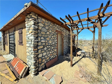 View of home's exterior with stone siding and log