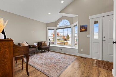 Entrance foyer featuring vaulted ceiling, hardwood / wood-style floors, and recessed lighting