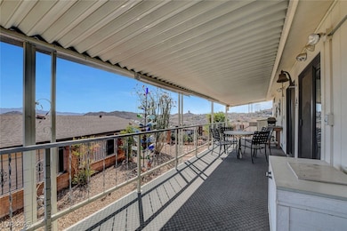 View of patio with outdoor dining area, a mountain