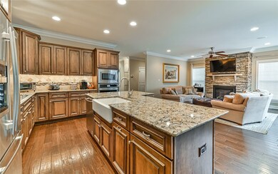 The gourmet style kitchen includes custom cabinets