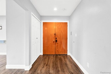 Entryway with baseboards and dark wood-style flooring