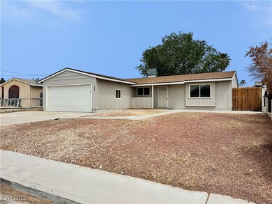 Ranch-style house with fence, a garage, and drivew