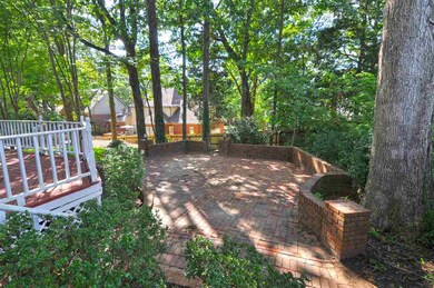 The backyard also features an additional brick pat