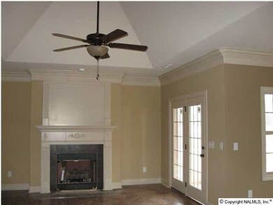 Great room with vaulted ceiling and gas-log fireplace.