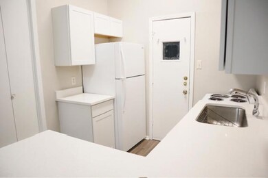 Kitchen with freestanding refrigerator, white cab