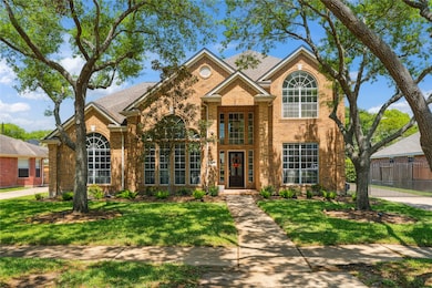 This stunning two-story brick beauty makes a grand