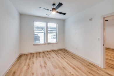 Spare room featuring visible vents, baseboards, wo