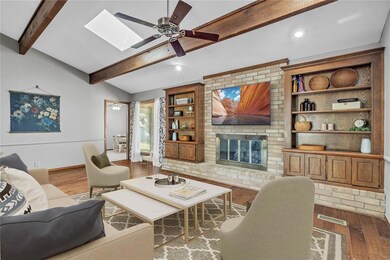 Living room with lofted ceiling with skylight, a f