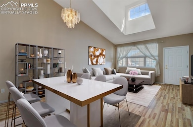 Virtually Staged Great Room looking back toward the front door.  Beautiful vaulted ceiling with high windows