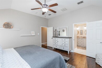 Bedroom with lofted ceiling, connected bathroom, d
