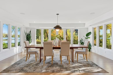 Floor-to-ceiling windows capture cinematic lake views.